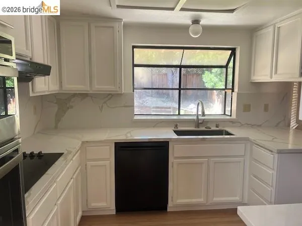 a kitchen with a sink stove and cabinets