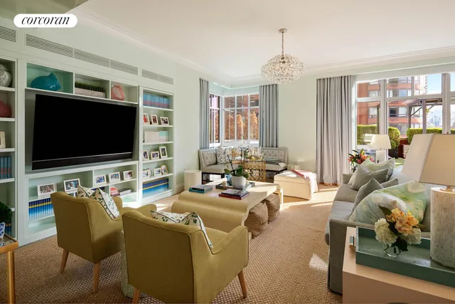 a living room with furniture windows and a chandelier