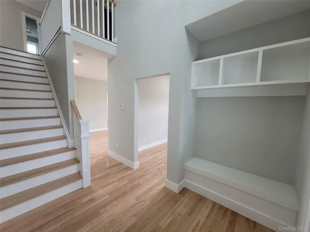 a view of entryway with wooden floor and stairs