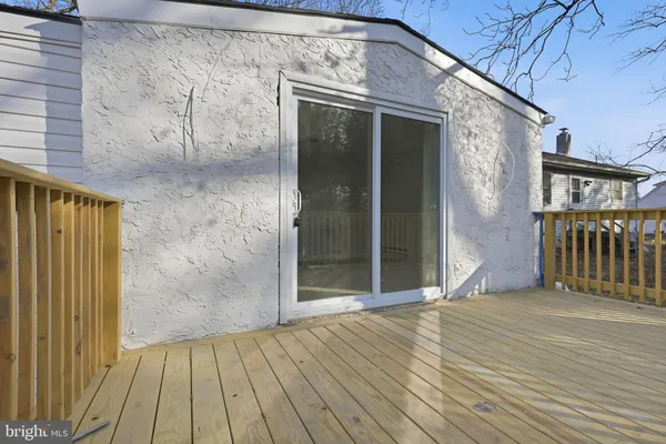 a view of a house with a wooden deck