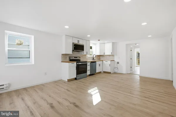a view of kitchen with sink microwave and stove