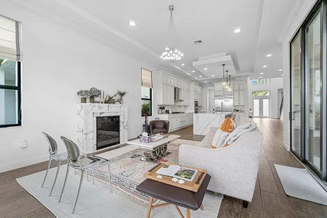 a living room with fireplace furniture and a large window