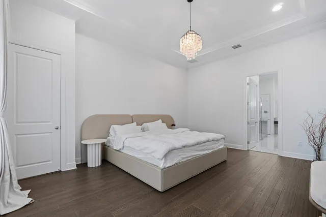 a spacious bedroom with a bed and a window