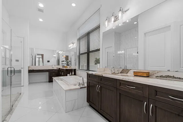 a bathroom with a tub sink and mirror
