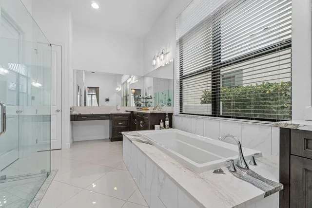 a bathroom with a shower and a glass door