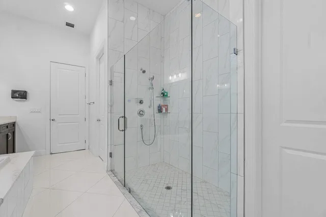 a spacious bathroom with a granite countertop sink and a bathtub
