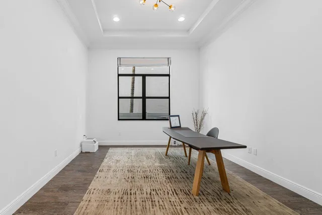 a kitchen with granite countertop white cabinets and sink