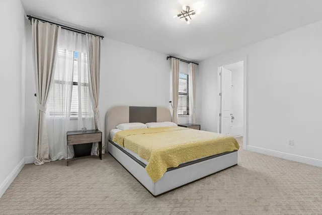 a bathroom with a granite countertop toilet sink and mirror