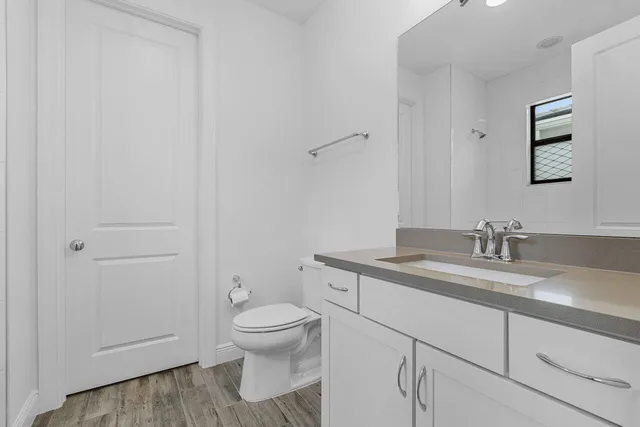 a white bath tub sitting next to a white cabinet