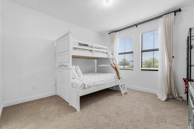 a bathroom with a granite countertop sink a toilet and a mirror