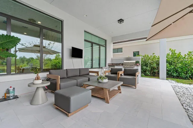 a view of a patio with a table and chairs under an umbrella