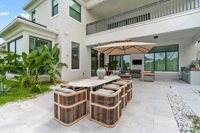 a view of a house with backyard sitting area and garden