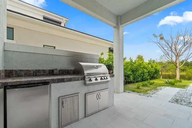 a living room with couches a flat screen tv and a large window with outer view