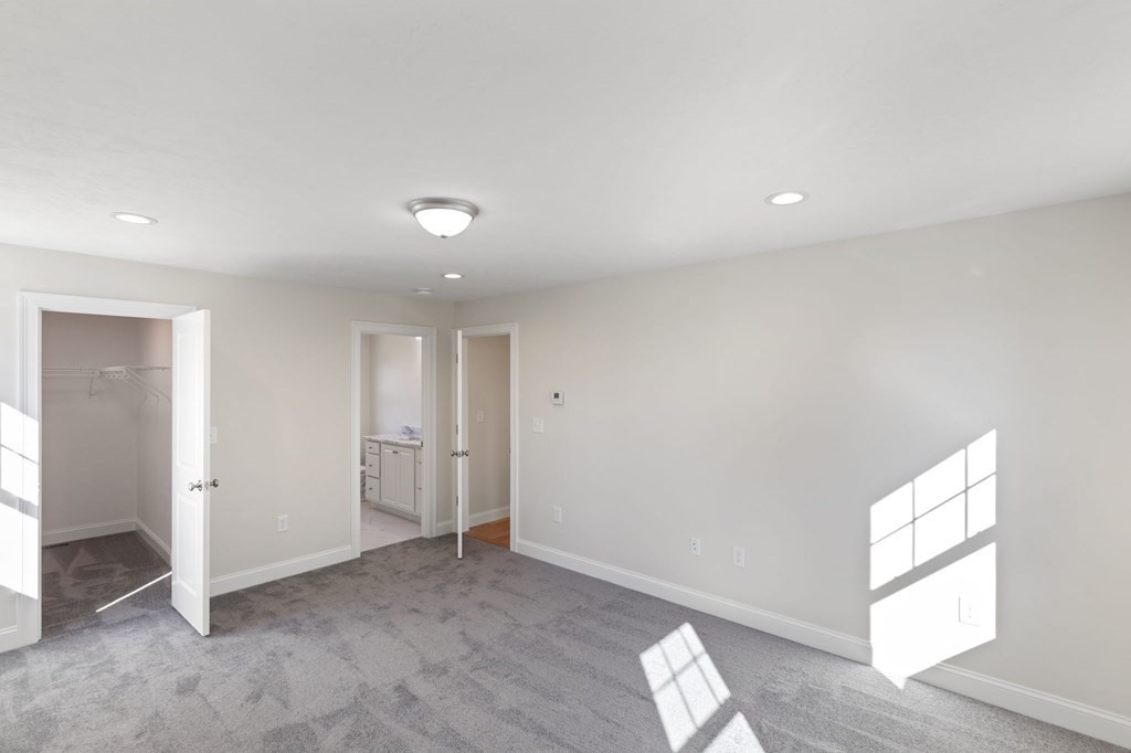 175 Rangeway Road Billerica, MA 01862 - Photo 12 of 18 an empty room with wooden floor and windows