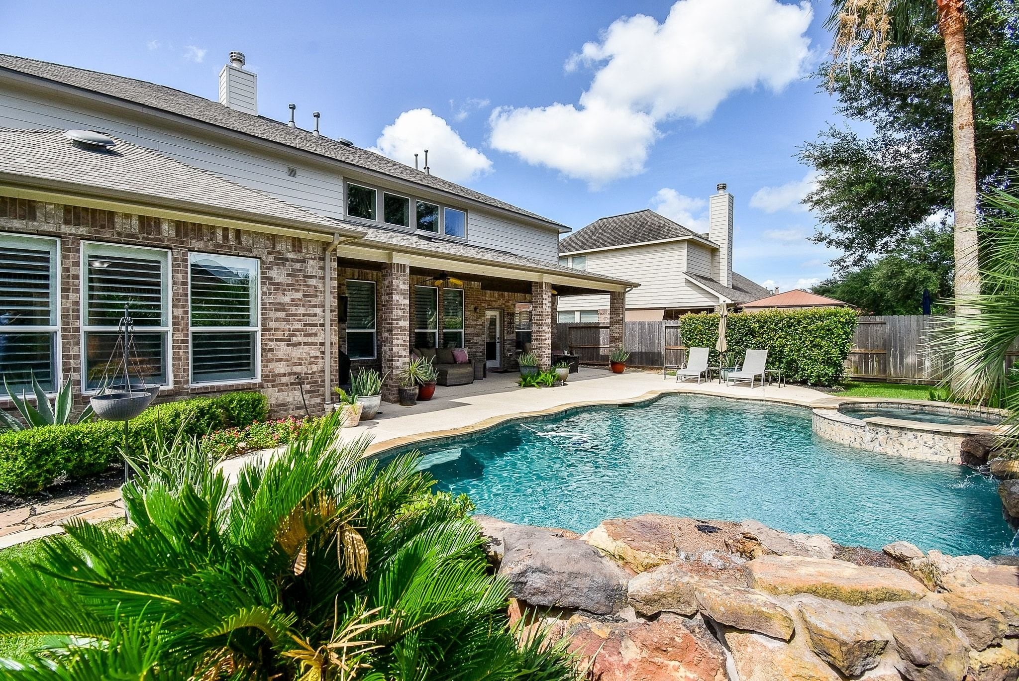 27607 Macklind Ridge Lane Katy, TX 77494 - Photo 9 of 50 Pool/Spa with rock water fall feature (recent main pump and pool heater 2022).
