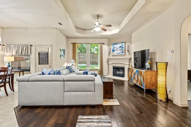 a living room with furniture a fireplace and a flat screen tv