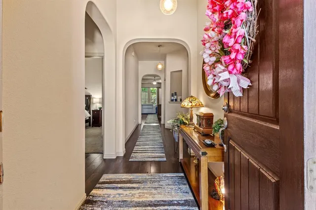 a view of a hallway with wooden floor and staircase