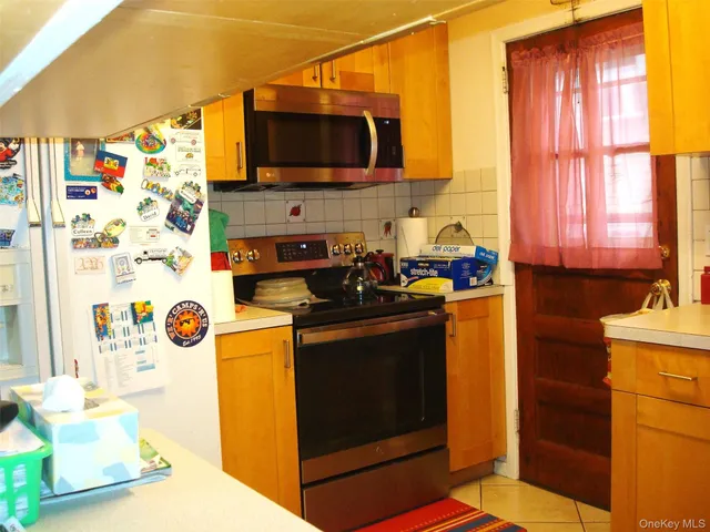 a kitchen with stainless steel appliances a stove a microwave a sink and cabinets