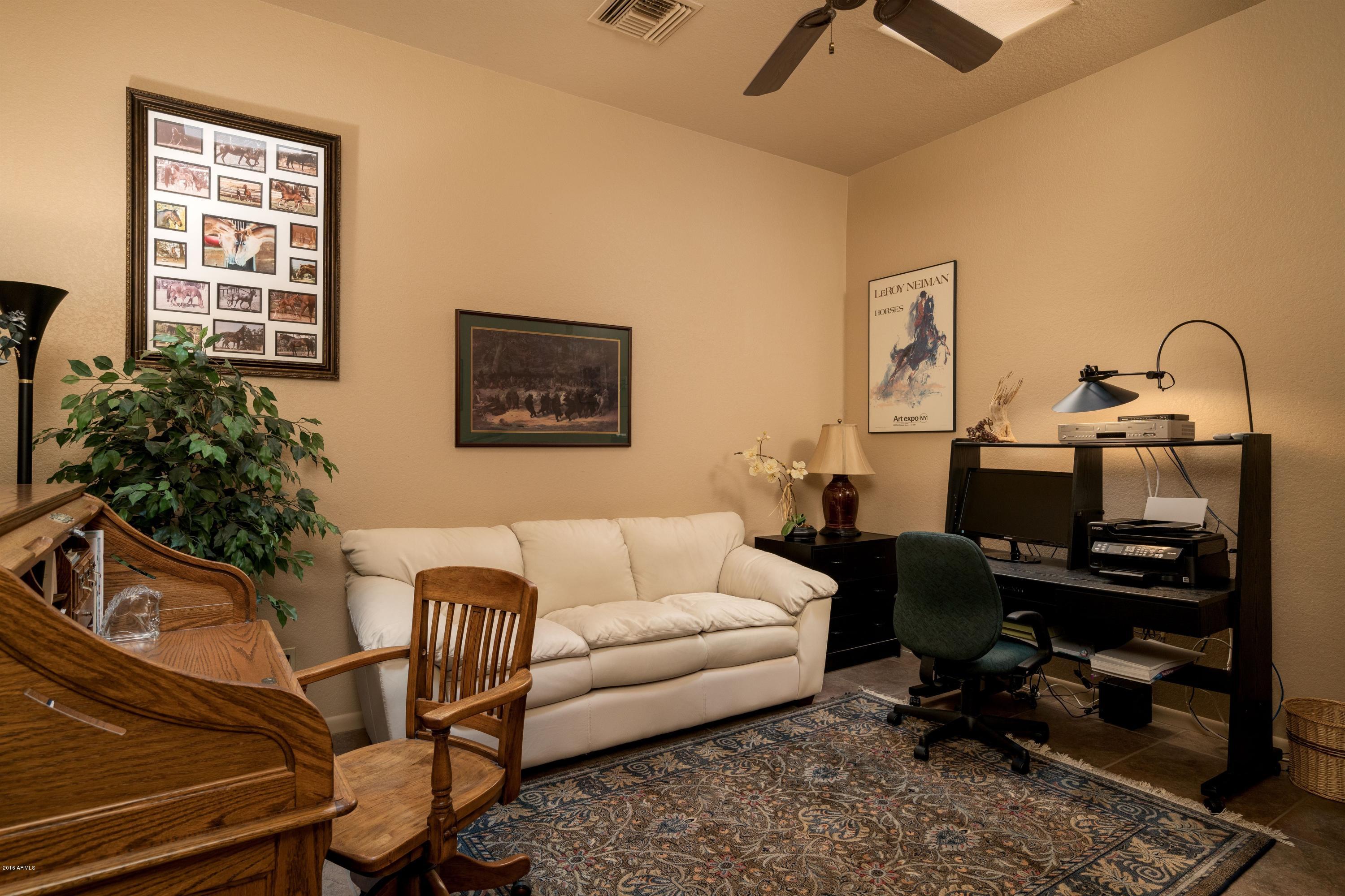 27913 North Quail Spring Road Rio Verde, AZ 85263 - Photo 13 of 63 a living room with furniture a rug and a window