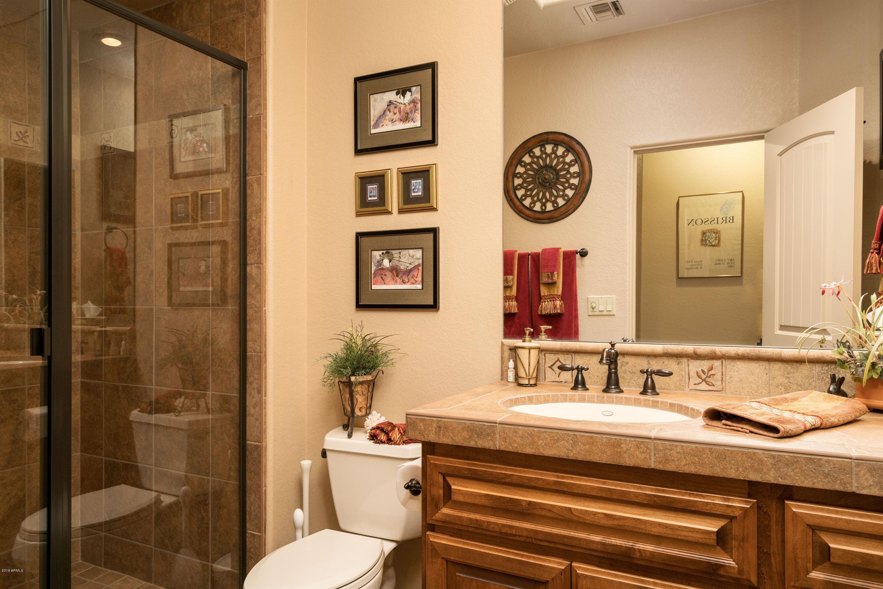 27913 North Quail Spring Road Rio Verde, AZ 85263 - Photo 17 of 63 a bathroom with a sink a toilet and shower