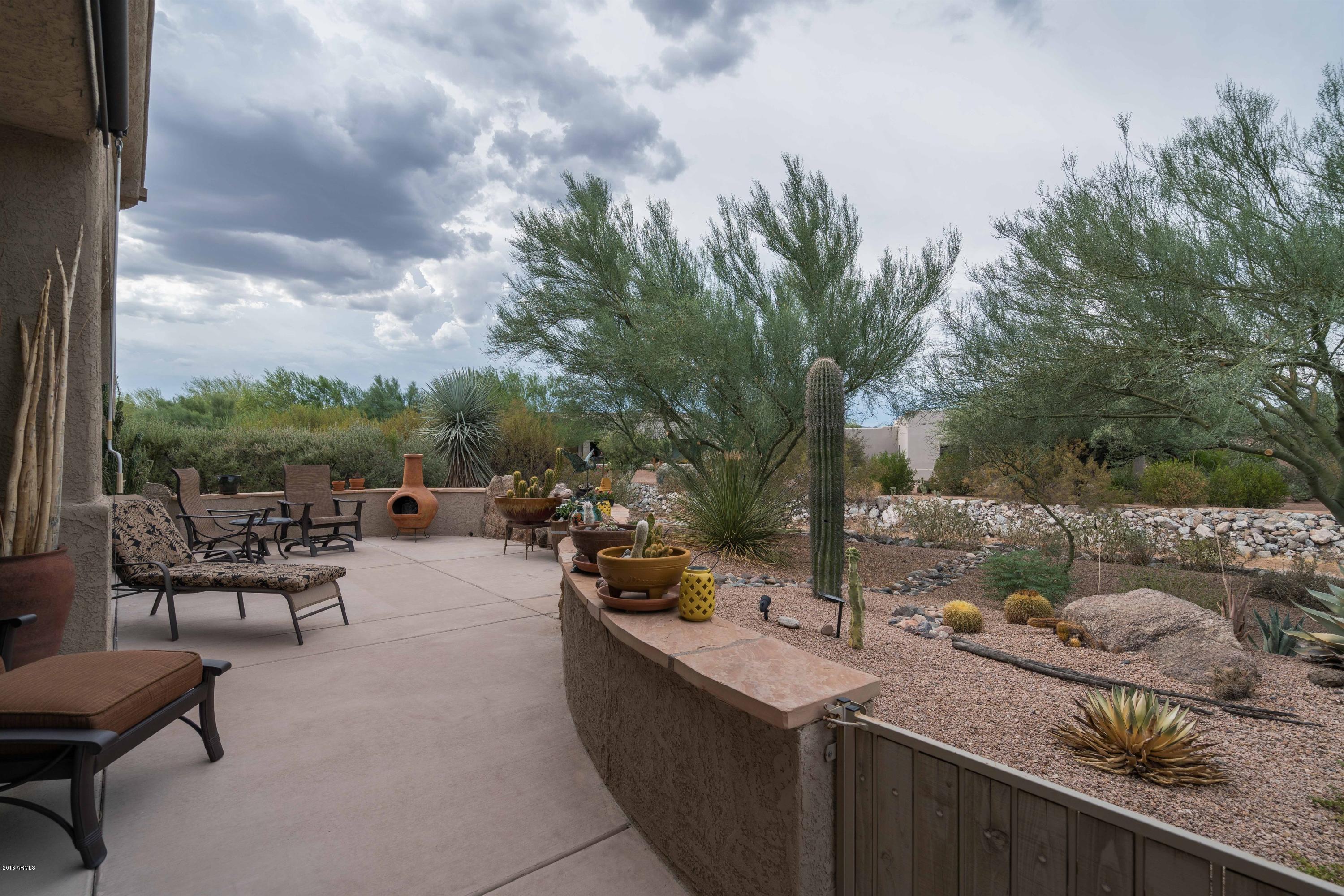 27913 North Quail Spring Road Rio Verde, AZ 85263 - Photo 20 of 63 a view of a terrace with furniture and a garden