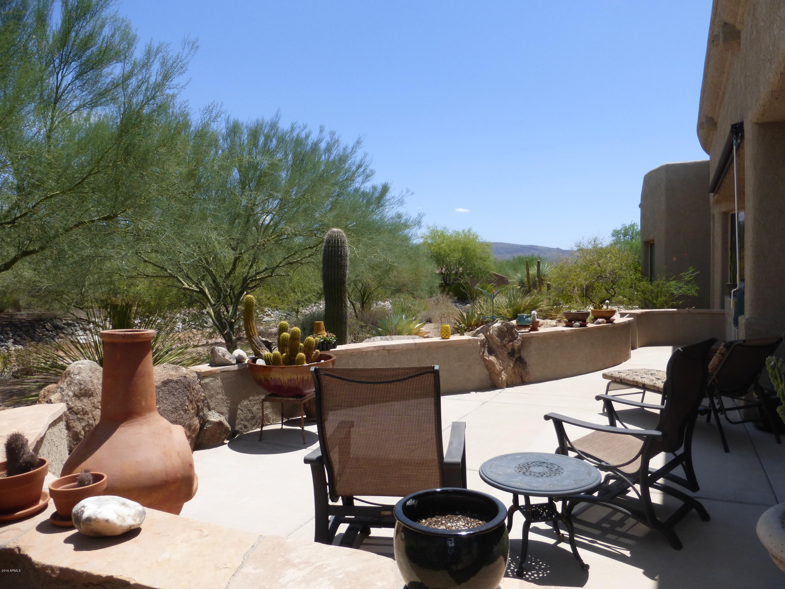 27913 North Quail Spring Road Rio Verde, AZ 85263 - Photo 22 of 63 a view of a patio with couches table and chairs and potted plants