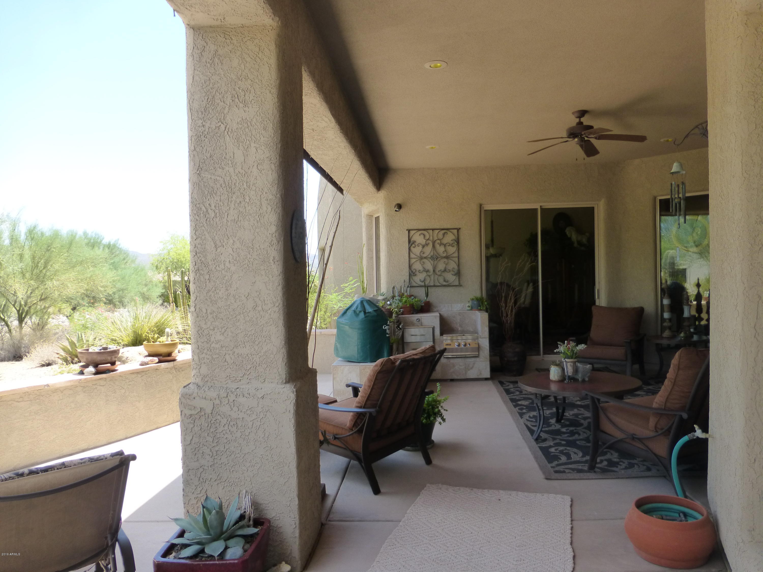 27913 North Quail Spring Road Rio Verde, AZ 85263 - Photo 29 of 63 a living room with furniture and a floor to ceiling window