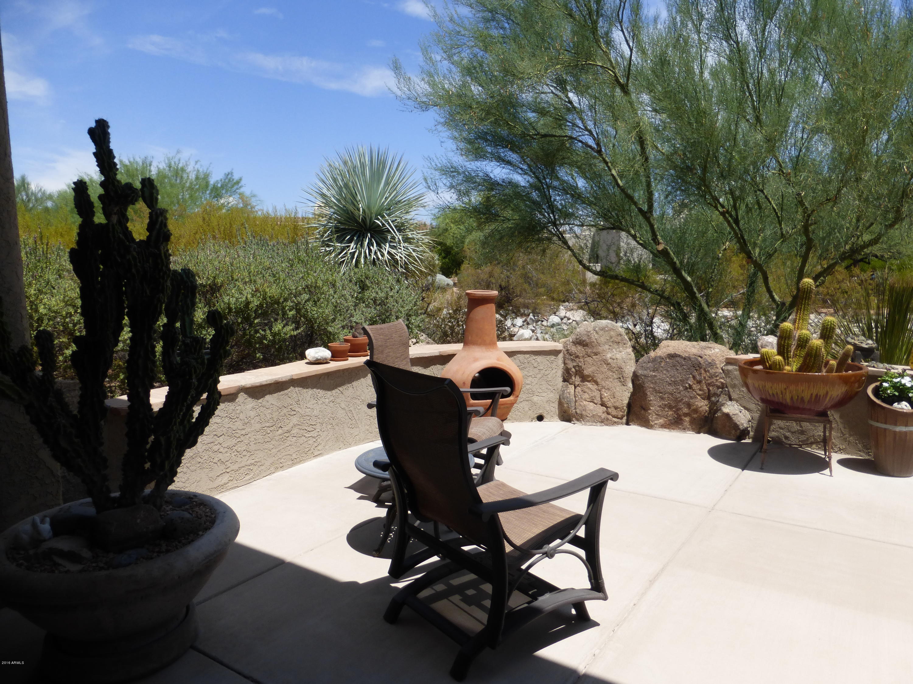 27913 North Quail Spring Road Rio Verde, AZ 85263 - Photo 30 of 63 a view of a chairs and table in backyard
