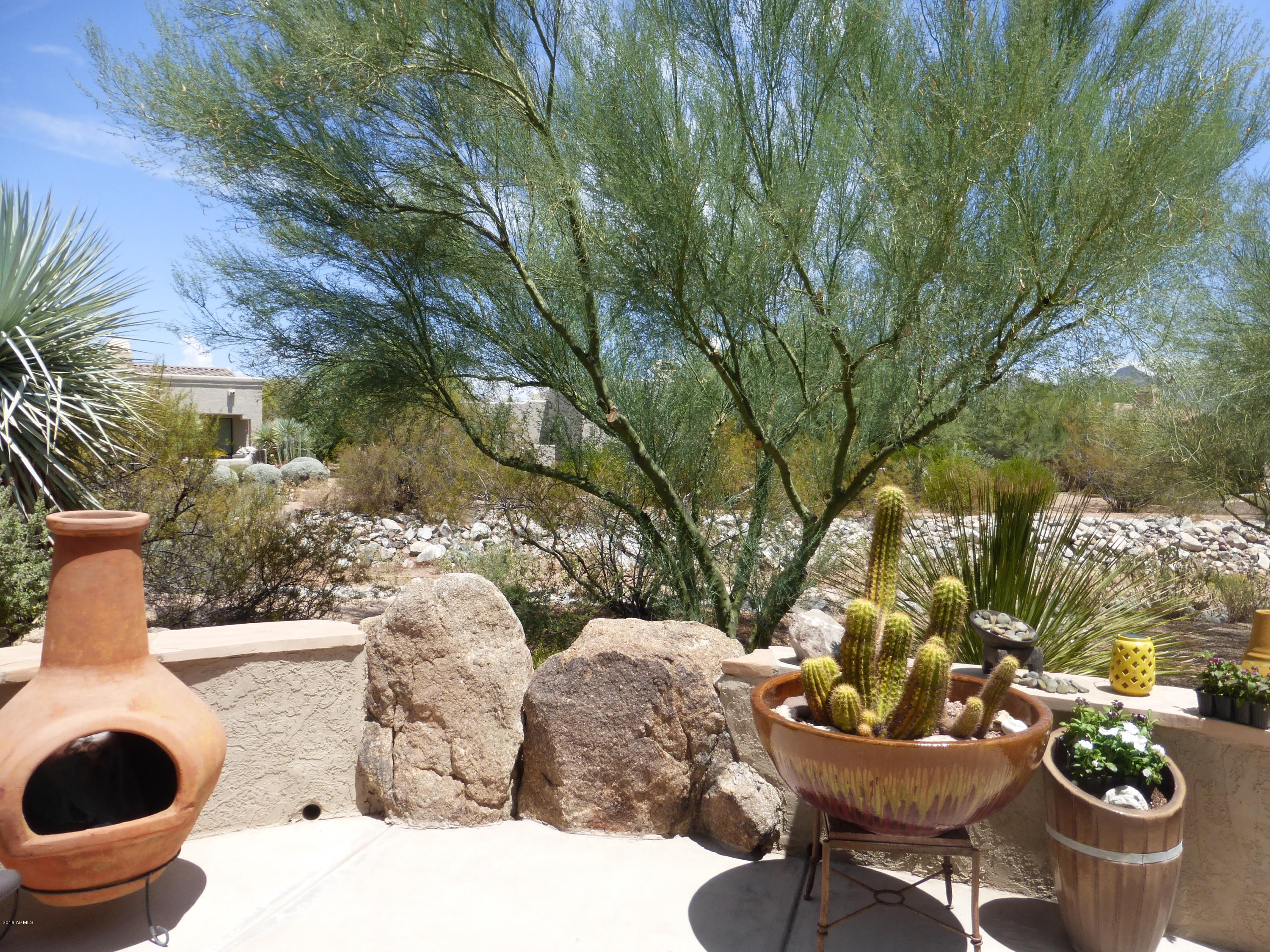 27913 North Quail Spring Road Rio Verde, AZ 85263 - Photo 32 of 63 a view of a chairs and table in backyard