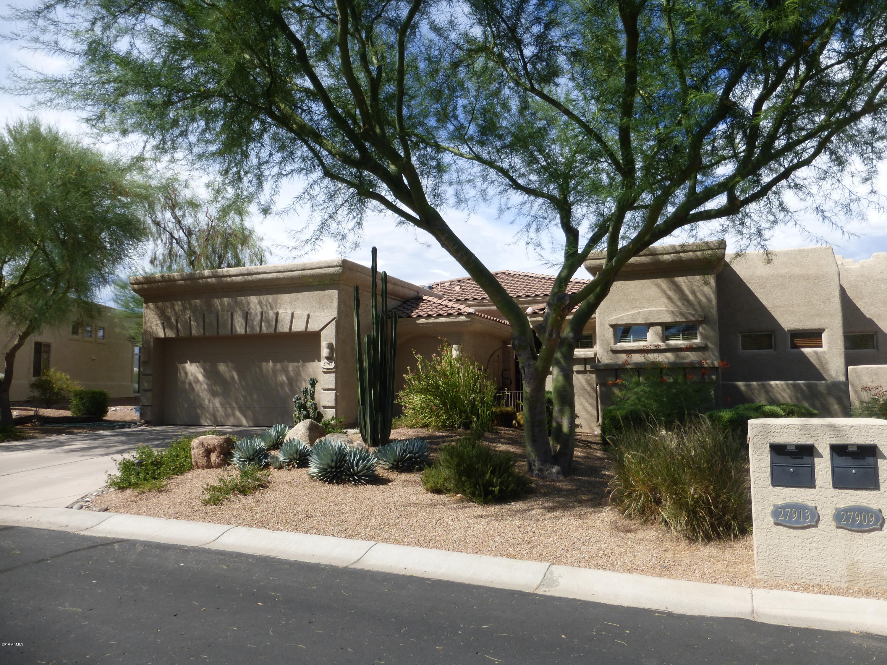 27913 North Quail Spring Road Rio Verde, AZ 85263 - Photo 4 of 63 a front view of a house with a yard and tree s