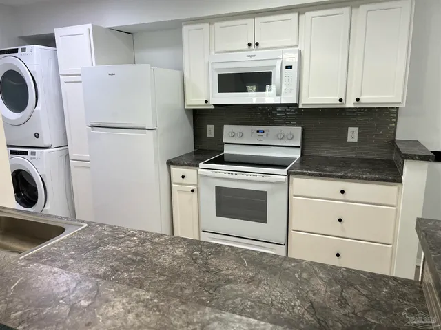 a kitchen with a stove top oven and refrigerator