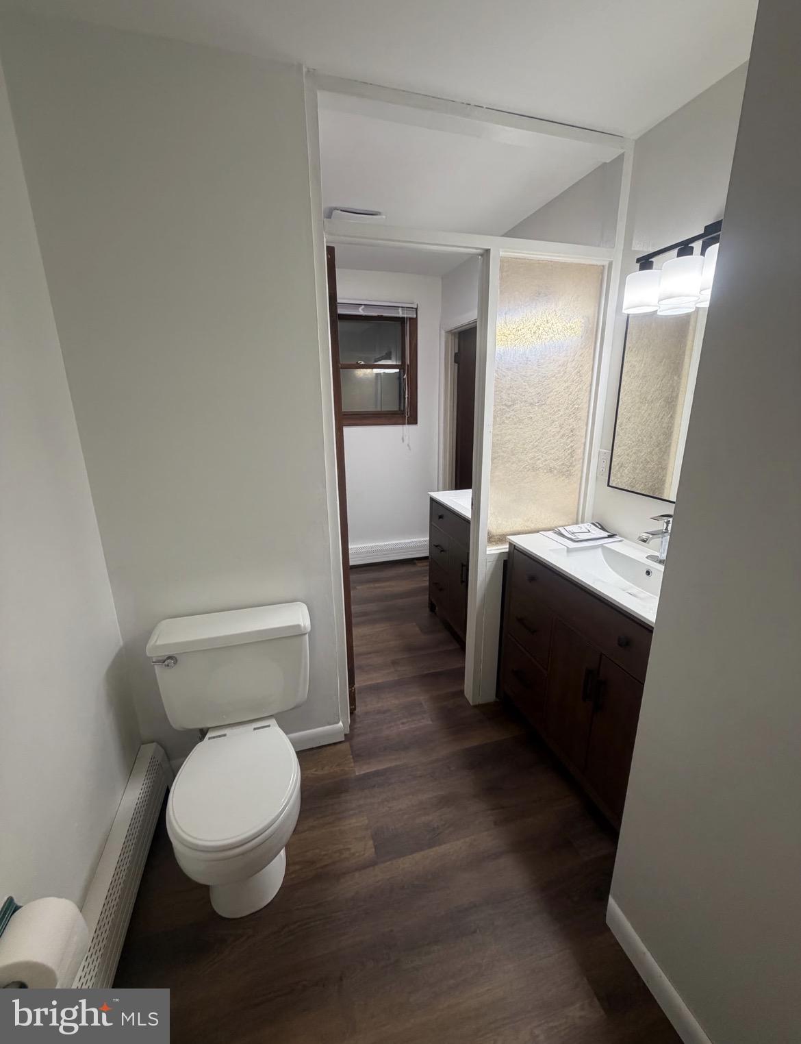 306 Gum Tree Road Coatesville, PA 19320 - Photo 8 of 15 a white toilet sitting next to a bathroom sink and a mirror
