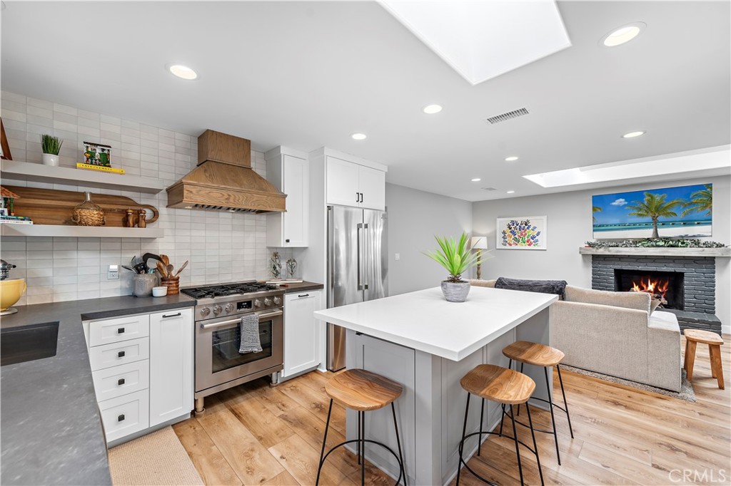 130 West Mariposa San Clemente, CA 92672 - Photo 11 of 42 a kitchen with stainless steel appliances a dining table chairs stove and sink