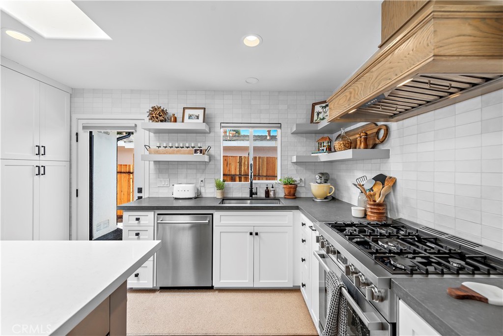130 West Mariposa San Clemente, CA 92672 - Photo 13 of 42 a kitchen with stainless steel appliances granite countertop a stove and a sink