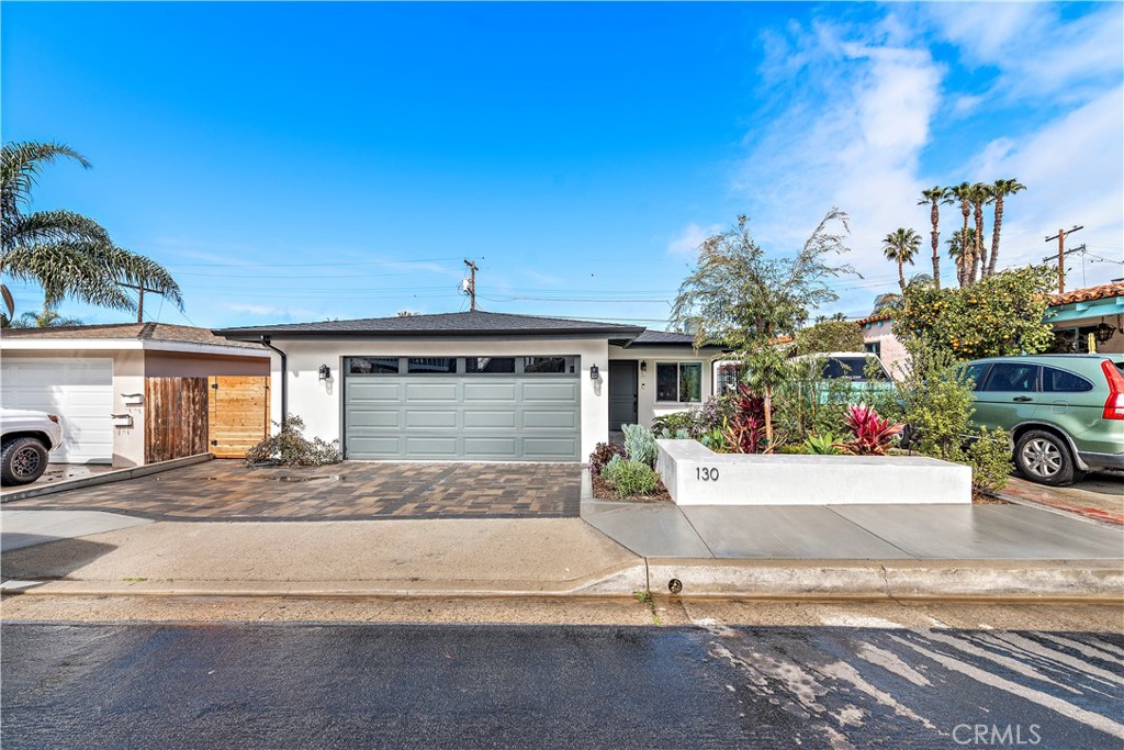 130 West Mariposa San Clemente, CA 92672 - Photo 2 of 42 a front view of a house with a yard and garage