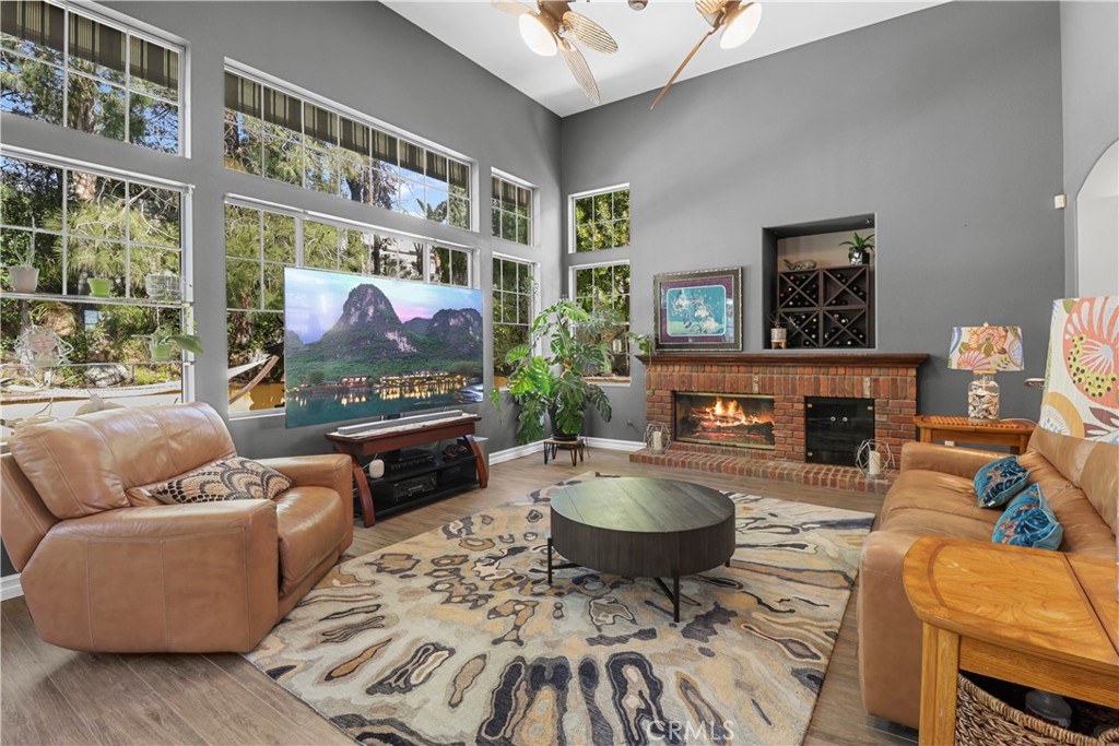 12786 North Rim Way Rancho Cucamonga, CA 91739 - Photo 12 of 50 a living room with furniture a fireplace and a floor to ceiling window