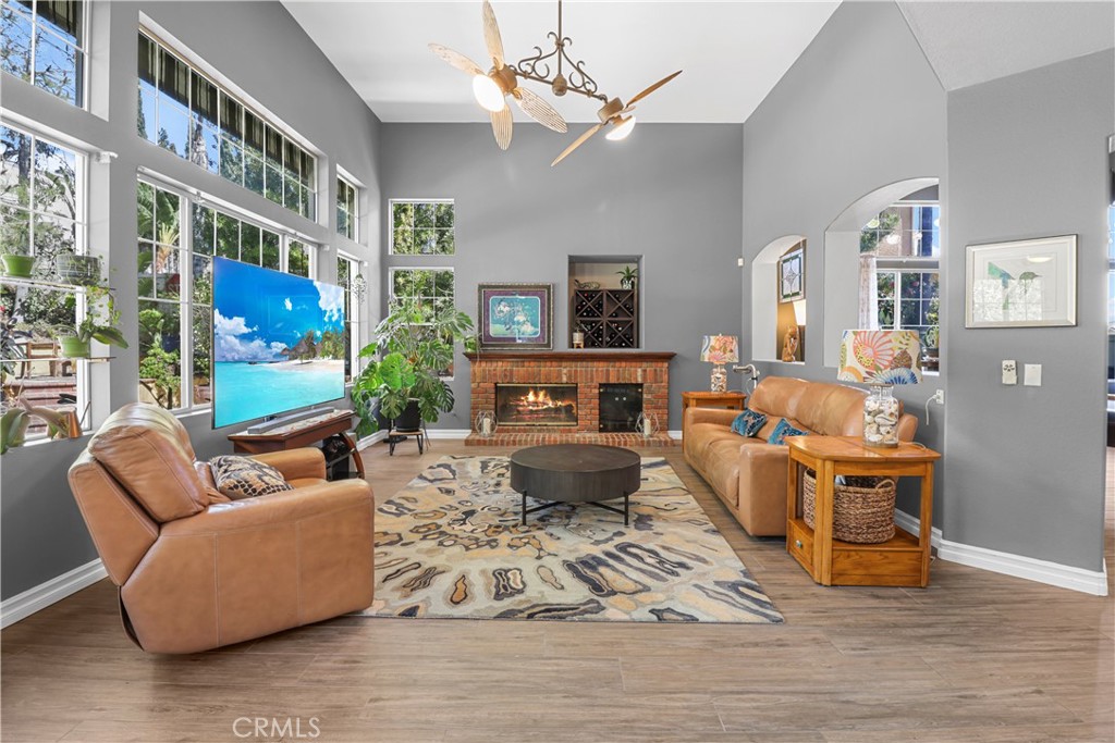 12786 North Rim Way Rancho Cucamonga, CA 91739 - Photo 13 of 50 a living room with furniture a fireplace and a large window
