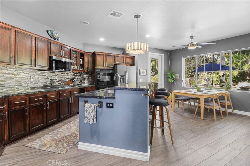 12786 North Rim Way Rancho Cucamonga, CA 91739 - Photo 16 of 50 a kitchen with lots of counter top space and dining table