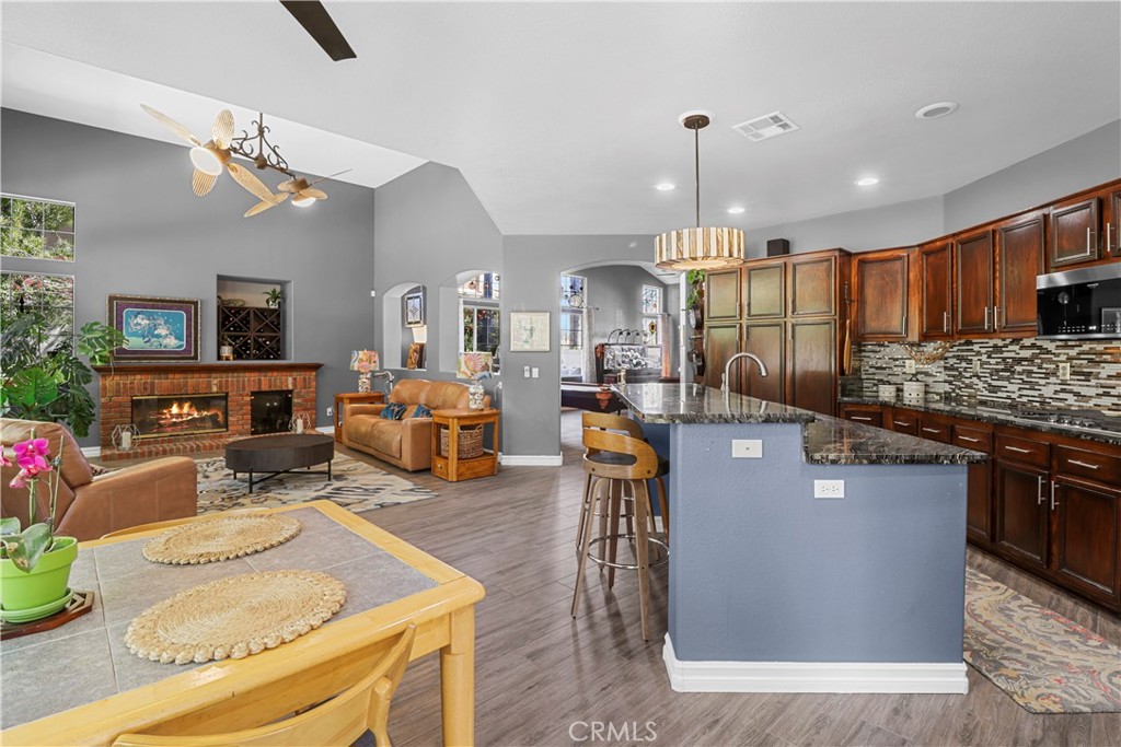 12786 North Rim Way Rancho Cucamonga, CA 91739 - Photo 18 of 50 a living room with furniture a chandelier and kitchen view