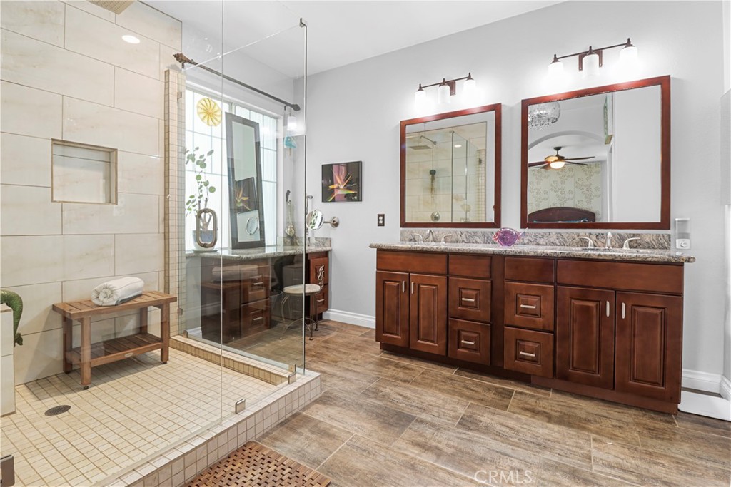 12786 North Rim Way Rancho Cucamonga, CA 91739 - Photo 28 of 50 a spacious bathroom with a granite countertop sink mirror and a bathtub
