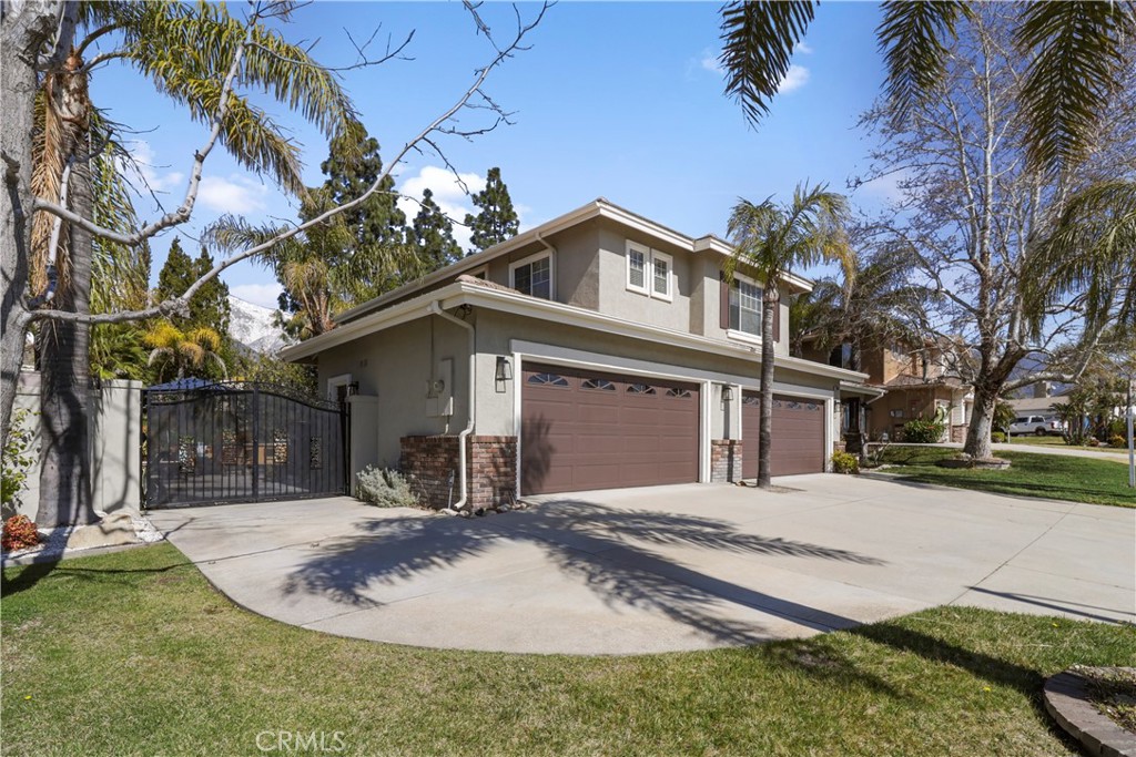 12786 North Rim Way Rancho Cucamonga, CA 91739 - Photo 47 of 50 a front view of a house with a yard and garage