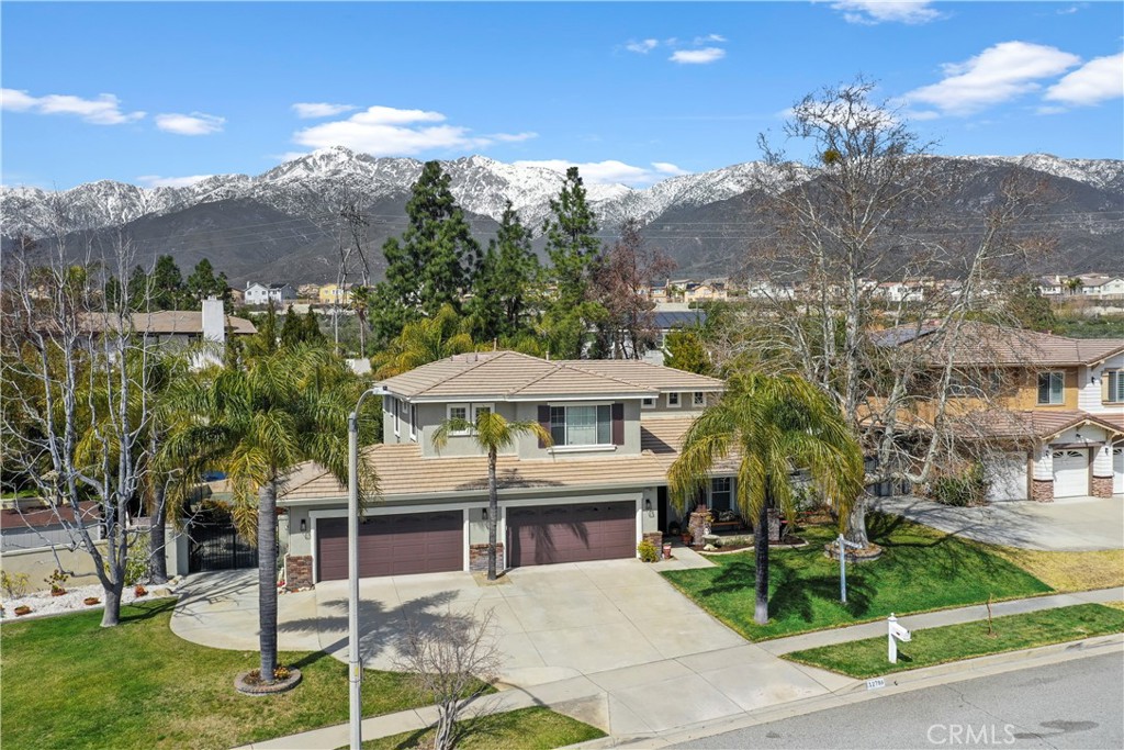 12786 North Rim Way Rancho Cucamonga, CA 91739 - Photo 48 of 50 a view of a house with a yard and table and chairs under an umbrella