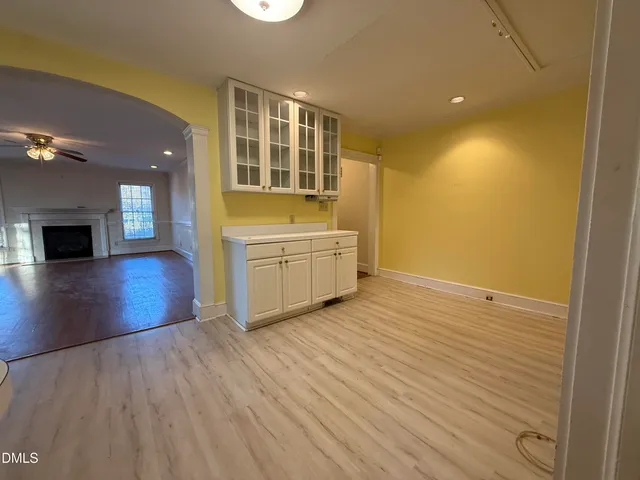 wooden floor in an empty room with a fireplace