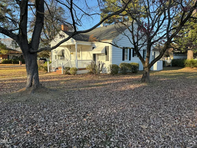 a view of a yard with a large tree