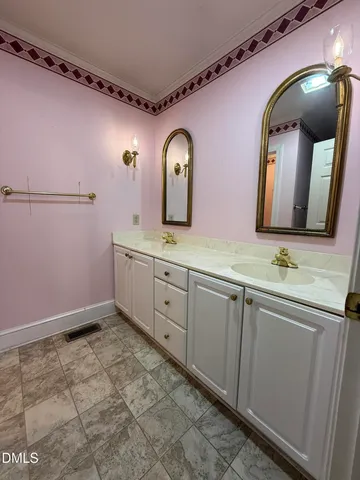 a bathroom with a double vanity sink and a mirror