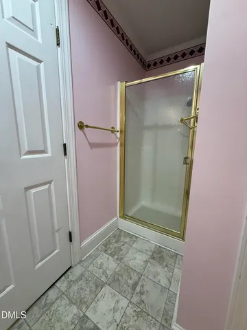 an empty room with wooden floor and windows with curtains view
