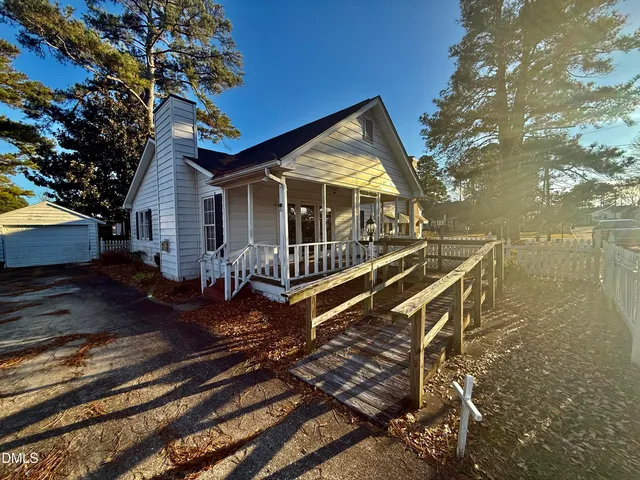 a view of a house with backyard and wooden floor