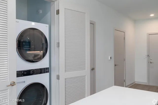 a bedroom with a bed and a washing machine