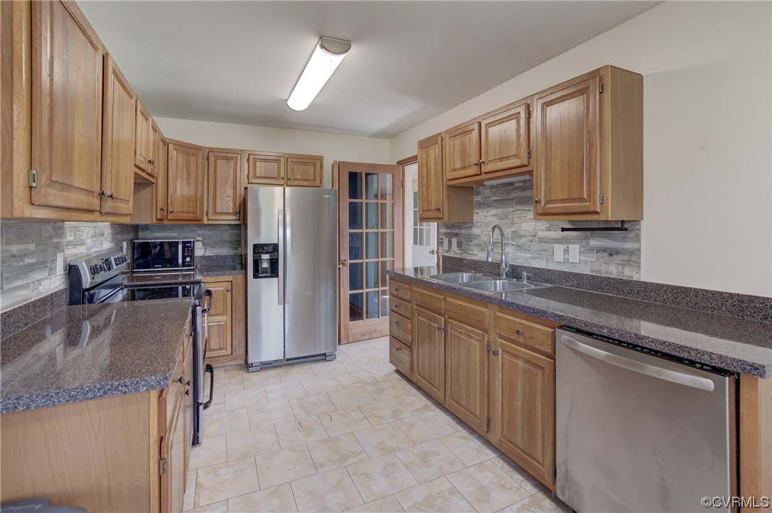 2567 Broad St Road Gum Spring, VA 23065 - Photo 8 of 38 a kitchen with stainless steel appliances granite countertop a refrigerator sink and stove