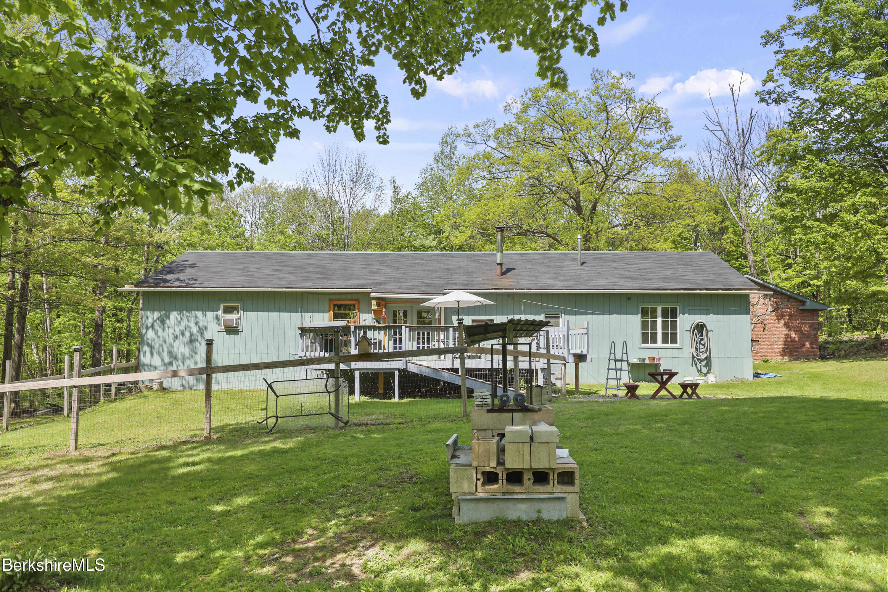 192 Curran Road Cheshire, MA 01225 - Photo 36 of 50 a backyard of a house with table and chairs